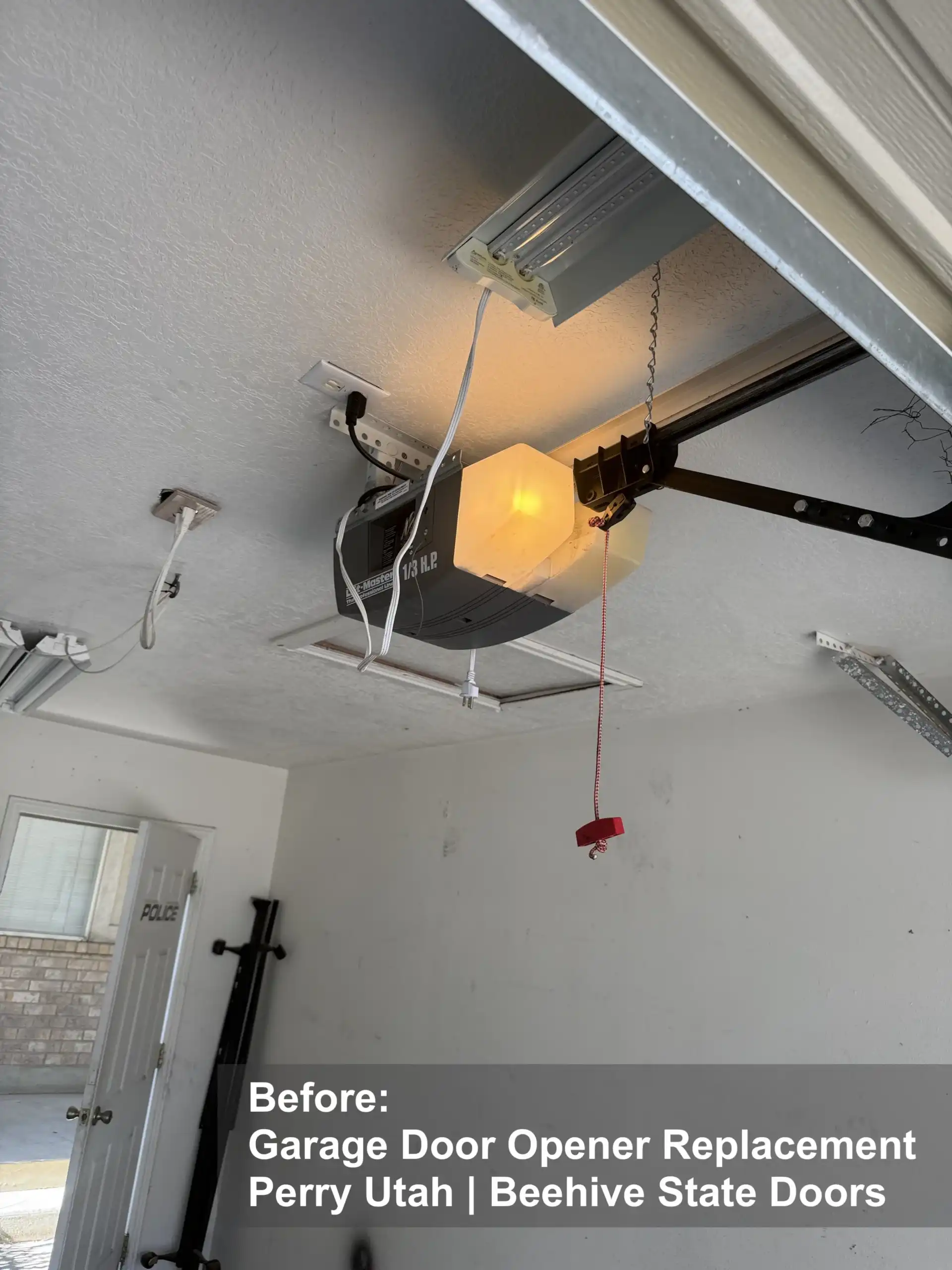 Old garage door opener before replacement in Perry Utah by Beehive State Doors