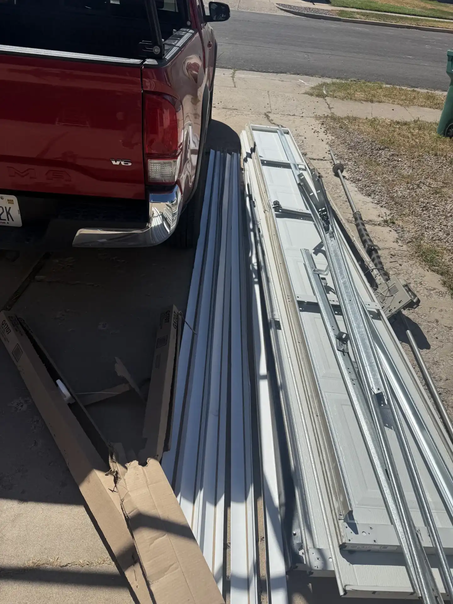 Old garage door panels and hardware removed during garage door replacement project in Kaysville Utah