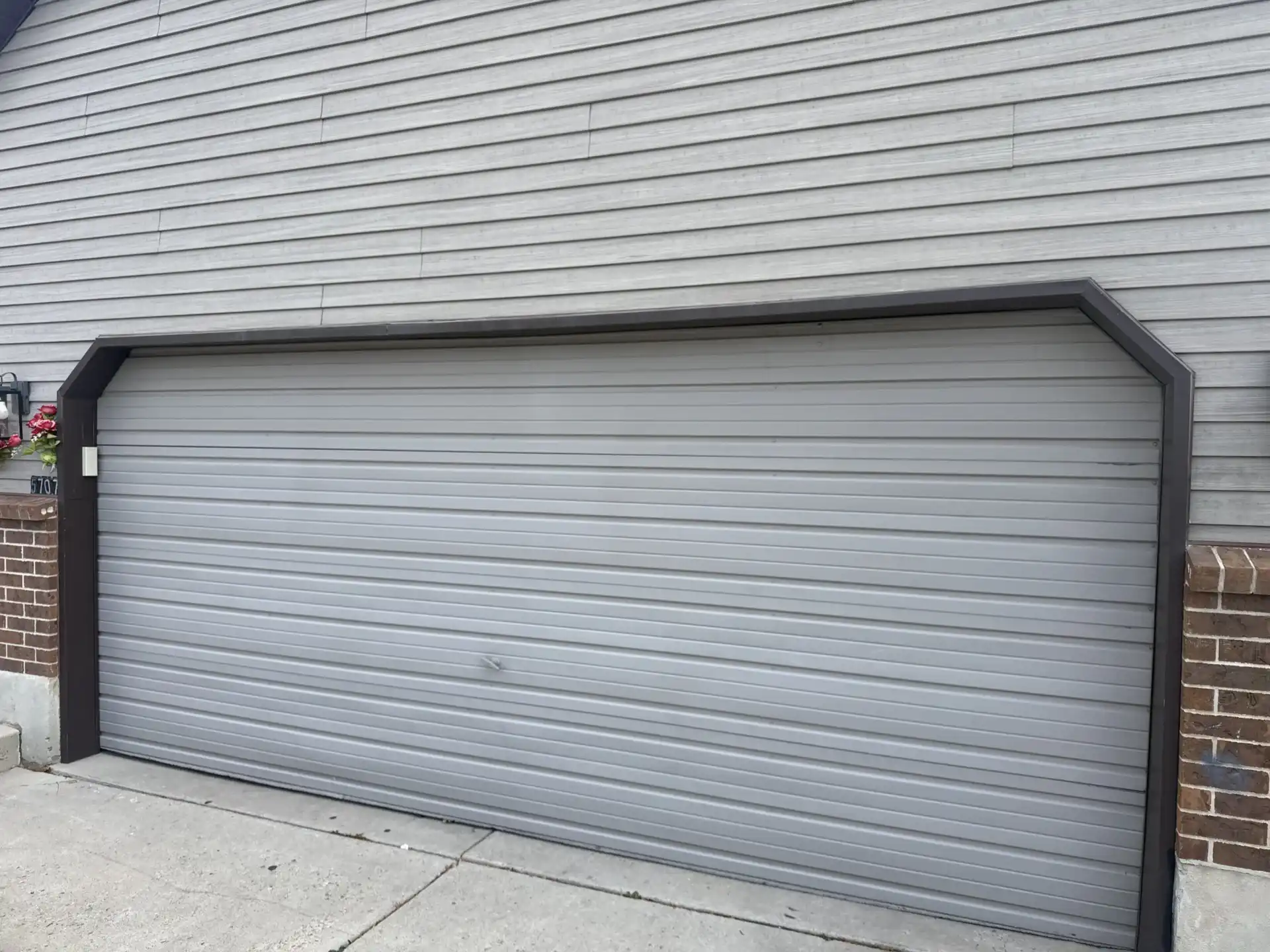 damaged residential garage door before replacement in Taylorsville Utah