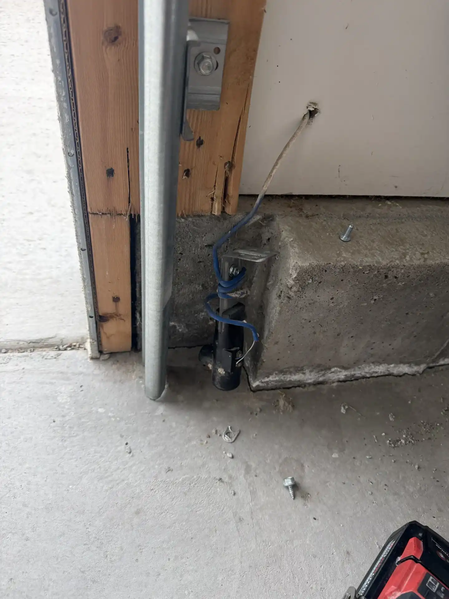 Garage door safety sensor misaligned before repair in Lehi Utah